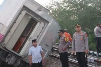 Polisi mengamankan gerbong Kereta Api (KA) Argo Bromo Anggrek yang anjlok di wialyah Kabupaten Subang, Jawa Barat, pada Jumat (1/8/2025).