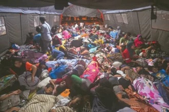 Ilustrasi warga korban bencana tidur berdesakan di tenda pengungsian.