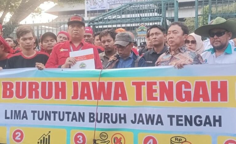TUNTUT KENAIKAN UPAH - Massa aksi buruh membentangkan spanduk bertuliskan sejumlah tuntutan saat menggelar aksi di depan Kantor Gubernur Jateng (Gubernuran) di Jalan Pahlawan, Kota Semarang, Kamis (1/10/2026).